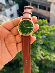 Green dial Seiko-inspired watch with gold-tone case and brown strap