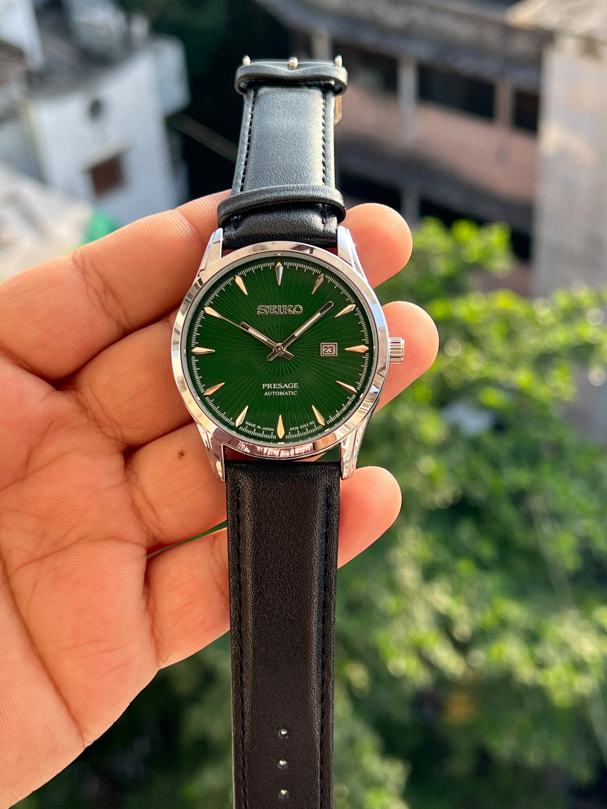 Green dial Seiko-inspired watch with silver-tone case and black leather-style strap
