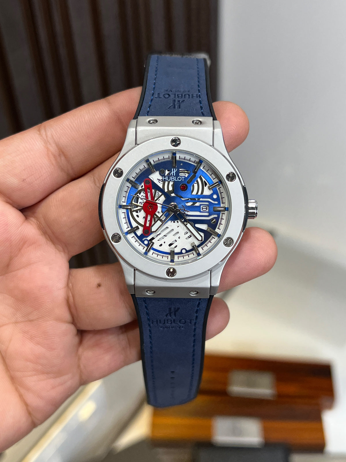 Blue skeleton dial Hublot style watch with silver-tone case