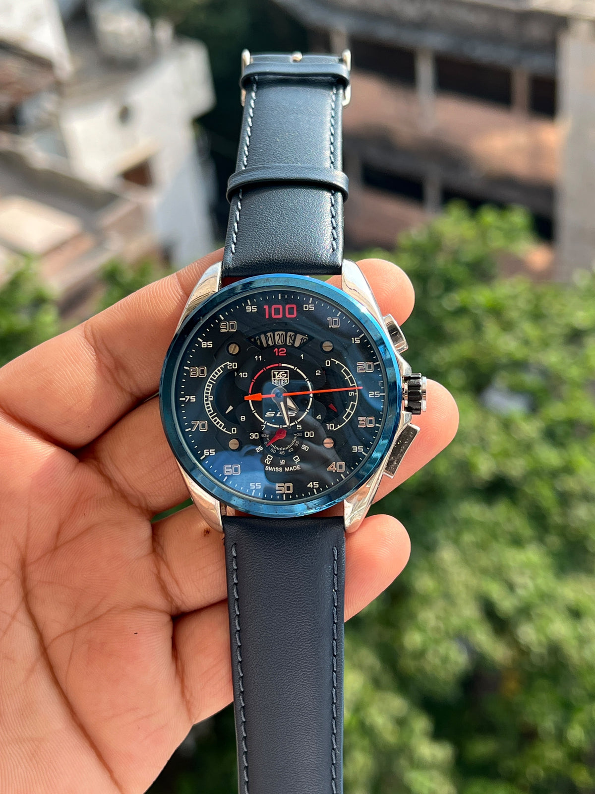 Black Carrera style chronograph watch with red dial accents