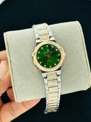 Green dial quartz watch with crystal style hour markers and two tone bracelet